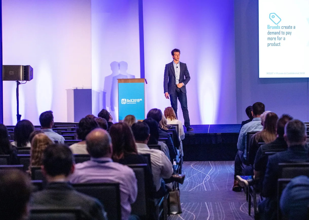 Jason presenting research to an audience at IIEX in 2019